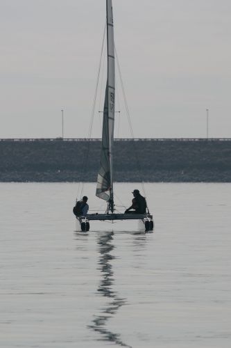 A Lonely Catamaran Waiting for Wind