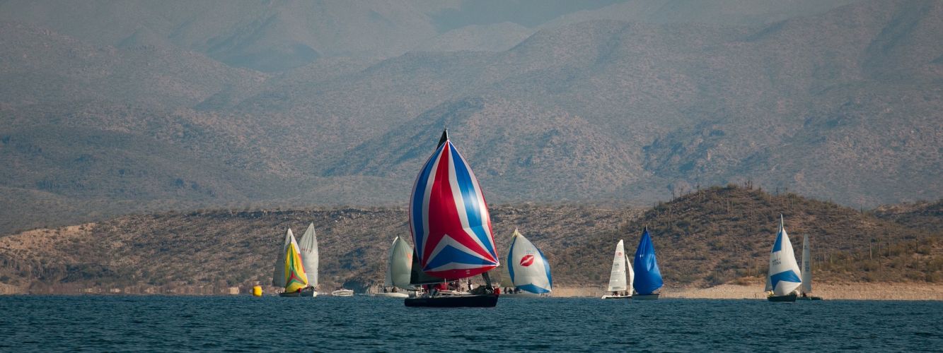 Spinnakers Against a Mountain Backdrop